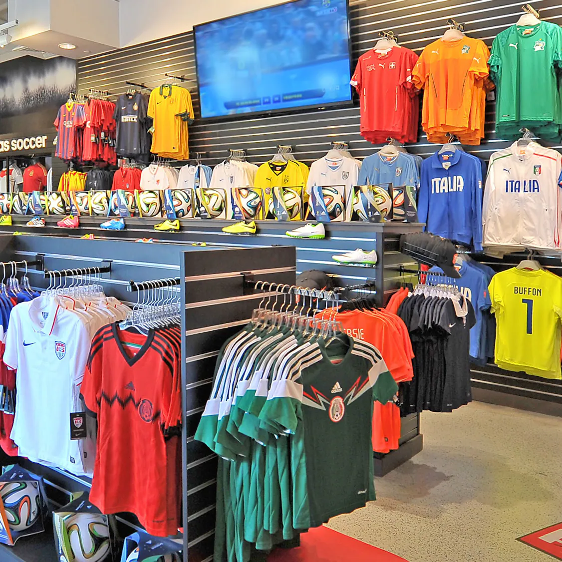 Retail display wall with multiple soccer jerseys and national team apparel