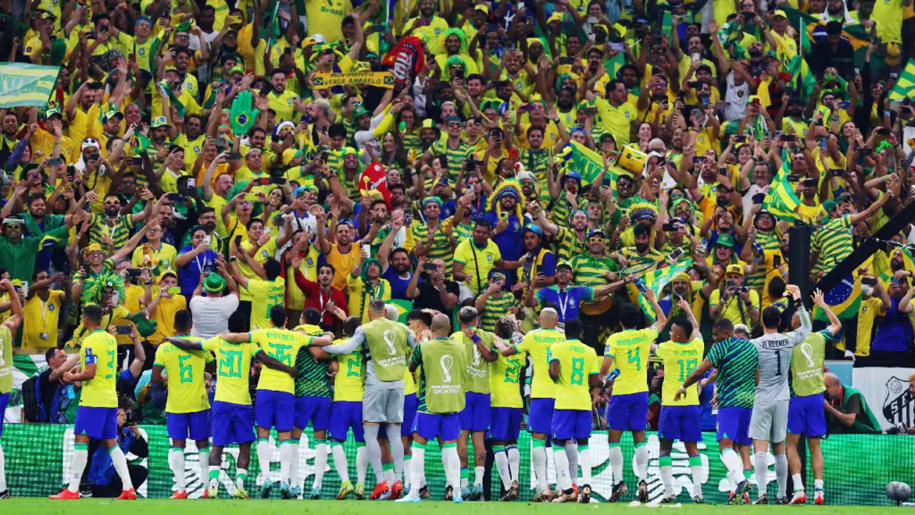 Football fans wearing national team jerseys and celebrating during a World Cup match