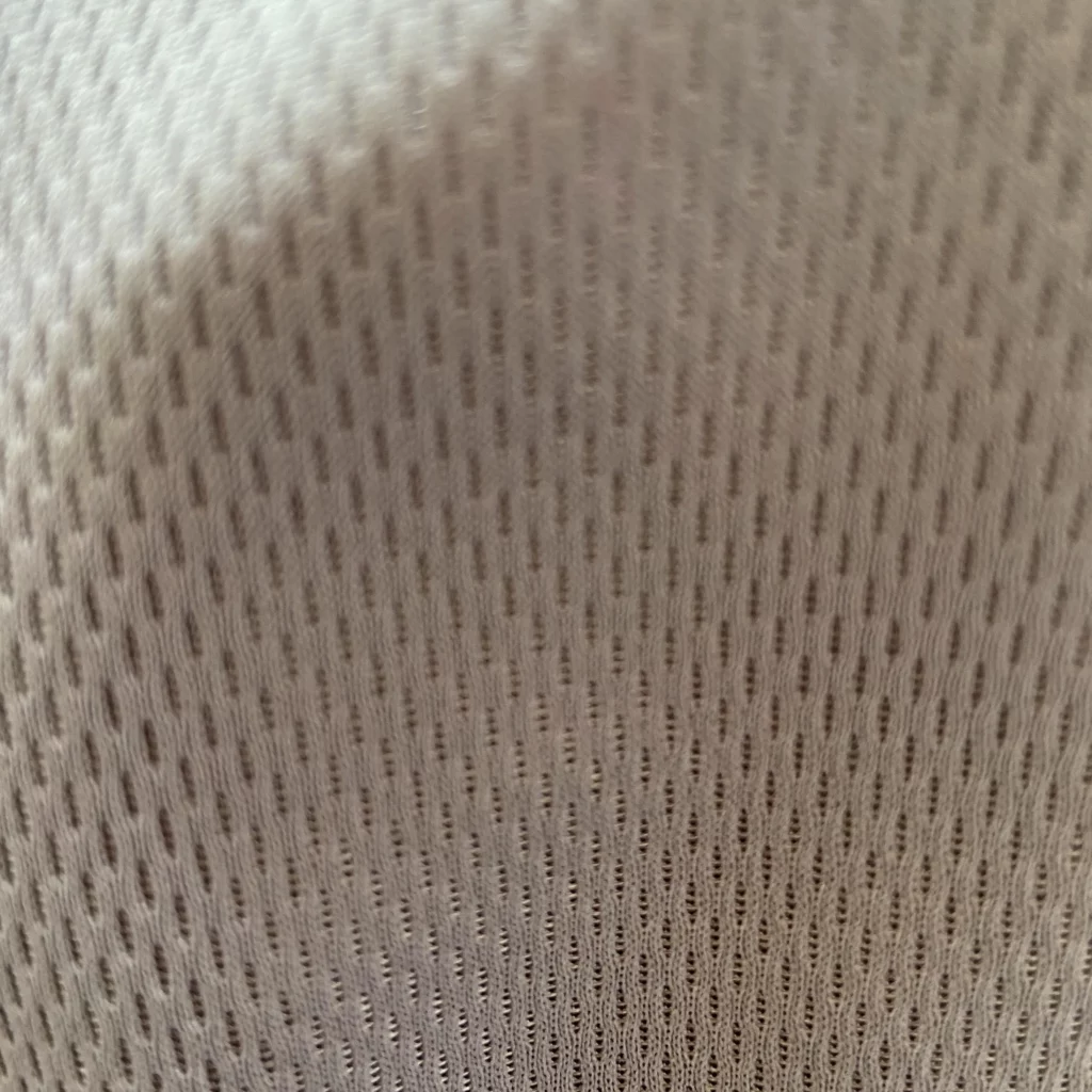 Close-up texture of football jersey mesh fabric used to evaluate supplier quality and material standards
